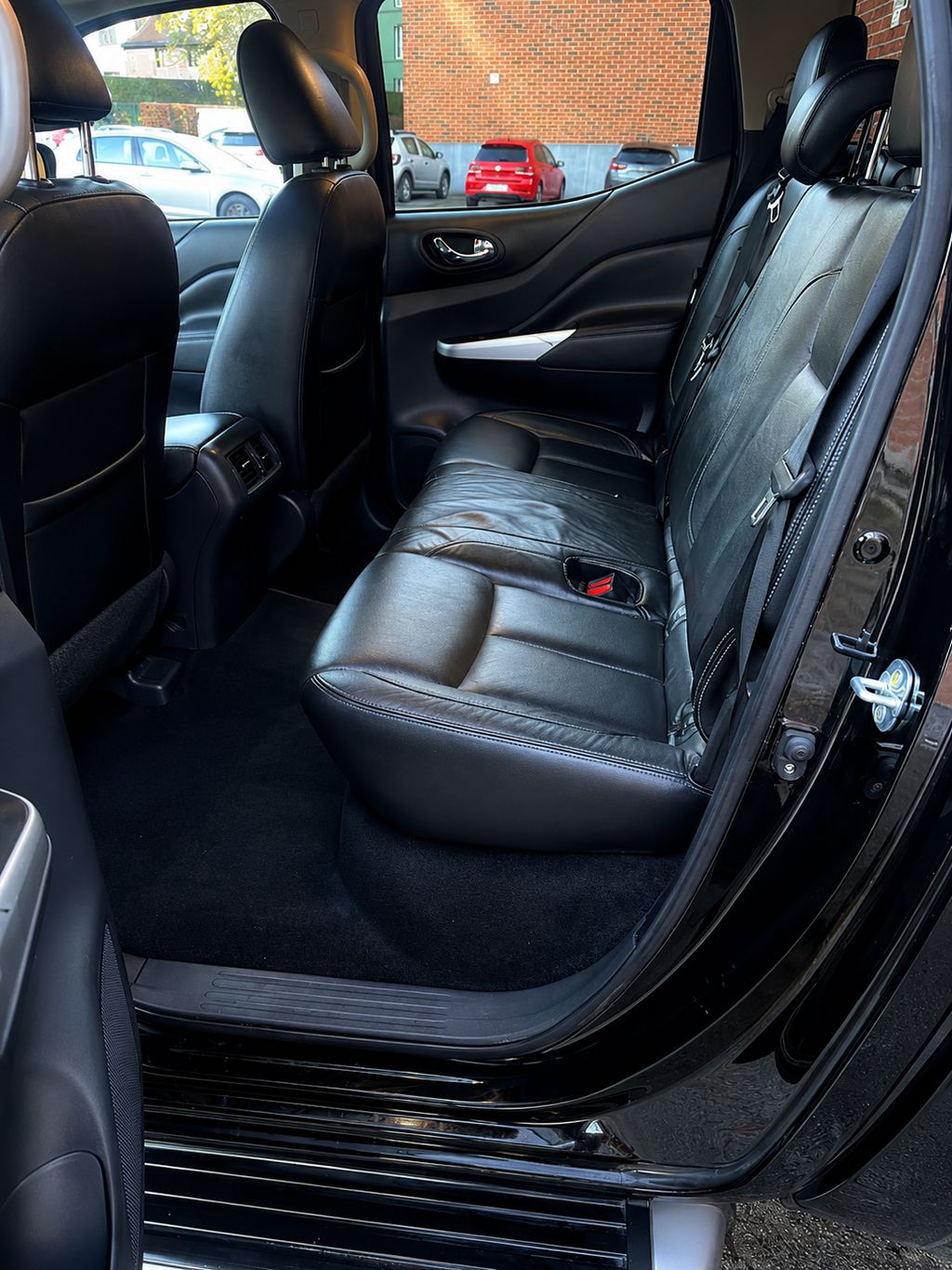 La même banquette arrière après nettoyage à la main, cuir et tapis remis à neuf